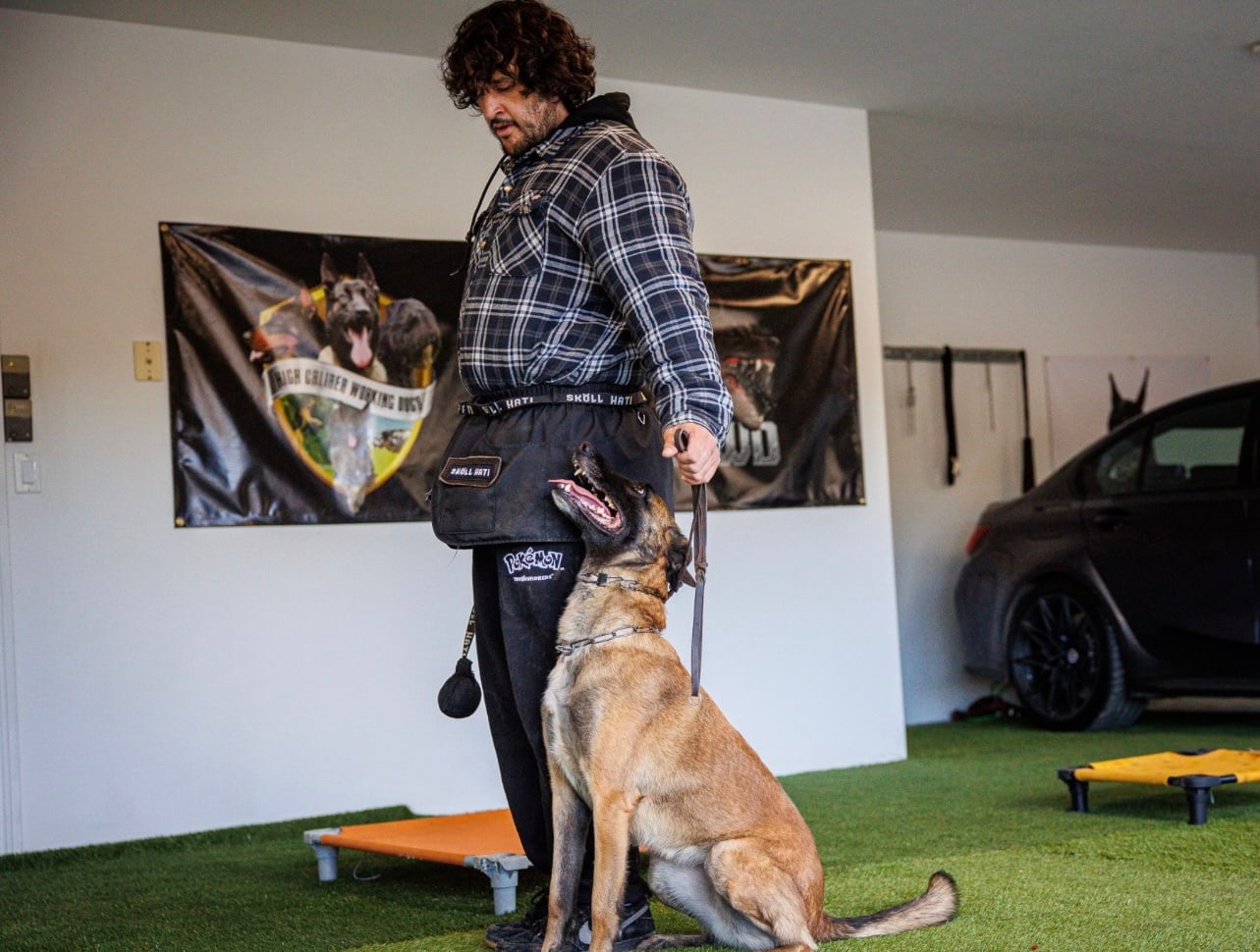 Andrew Pena working with a dog at our Upland facility